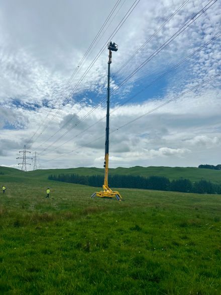 Tracked Spider 54m going up to fix electricity pylon